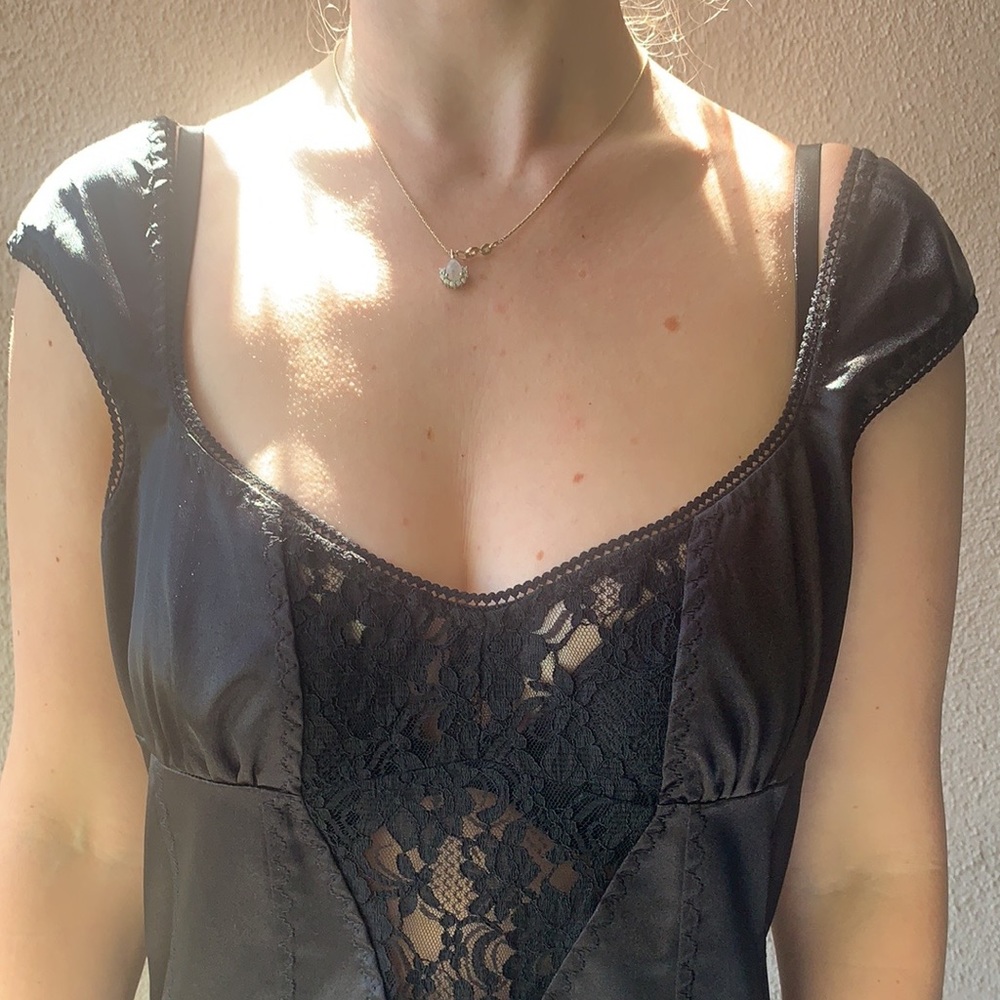 D&G Black cocktail dress with lace inlay and detailed stitching .
